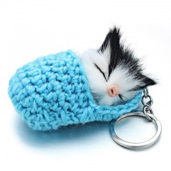 Sleeping cat in a hand-woven cot - keychainKeyrings